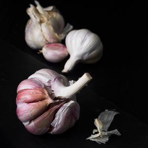 Close-up of fresh garlic cloves used in Black Magic salt