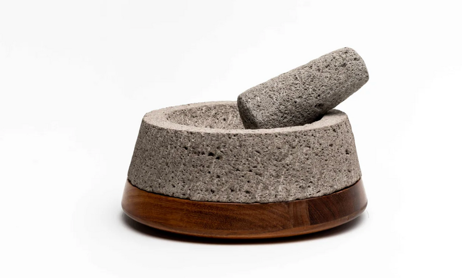 Molcajete being used to grind chilies and spices