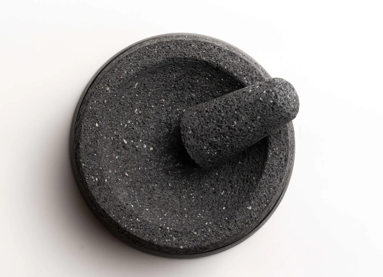 Whole spices ready to grind in a lava stone molcajete